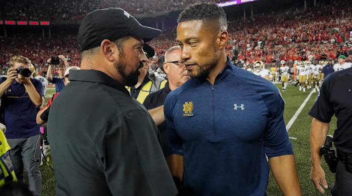Ohio State coach Ryan Day shakes hands with Notre Dame coach Marcus Freeman.